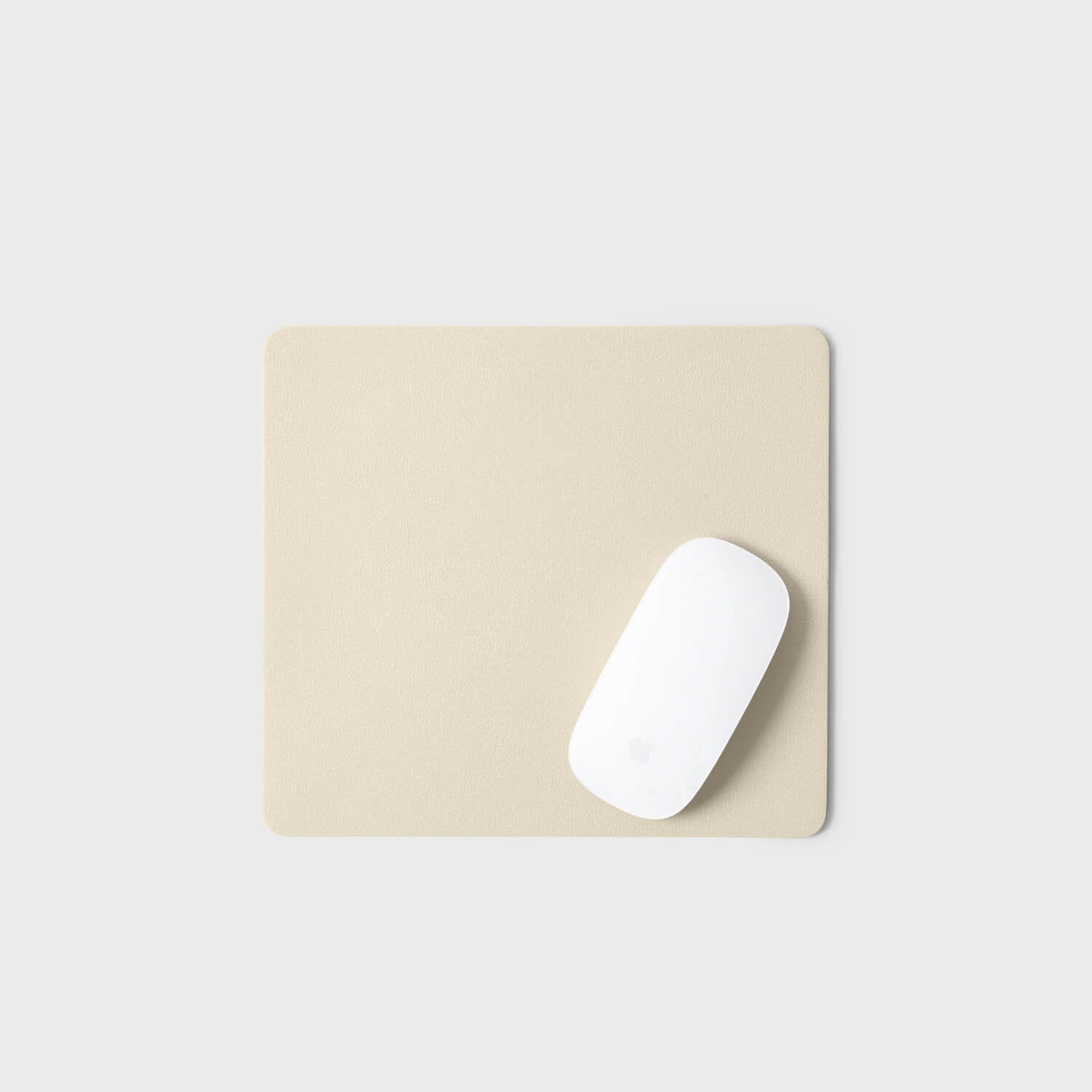 Modern mouse pad in neutral color with a sleek white mouse, showcasing minimalist Leatherology design.