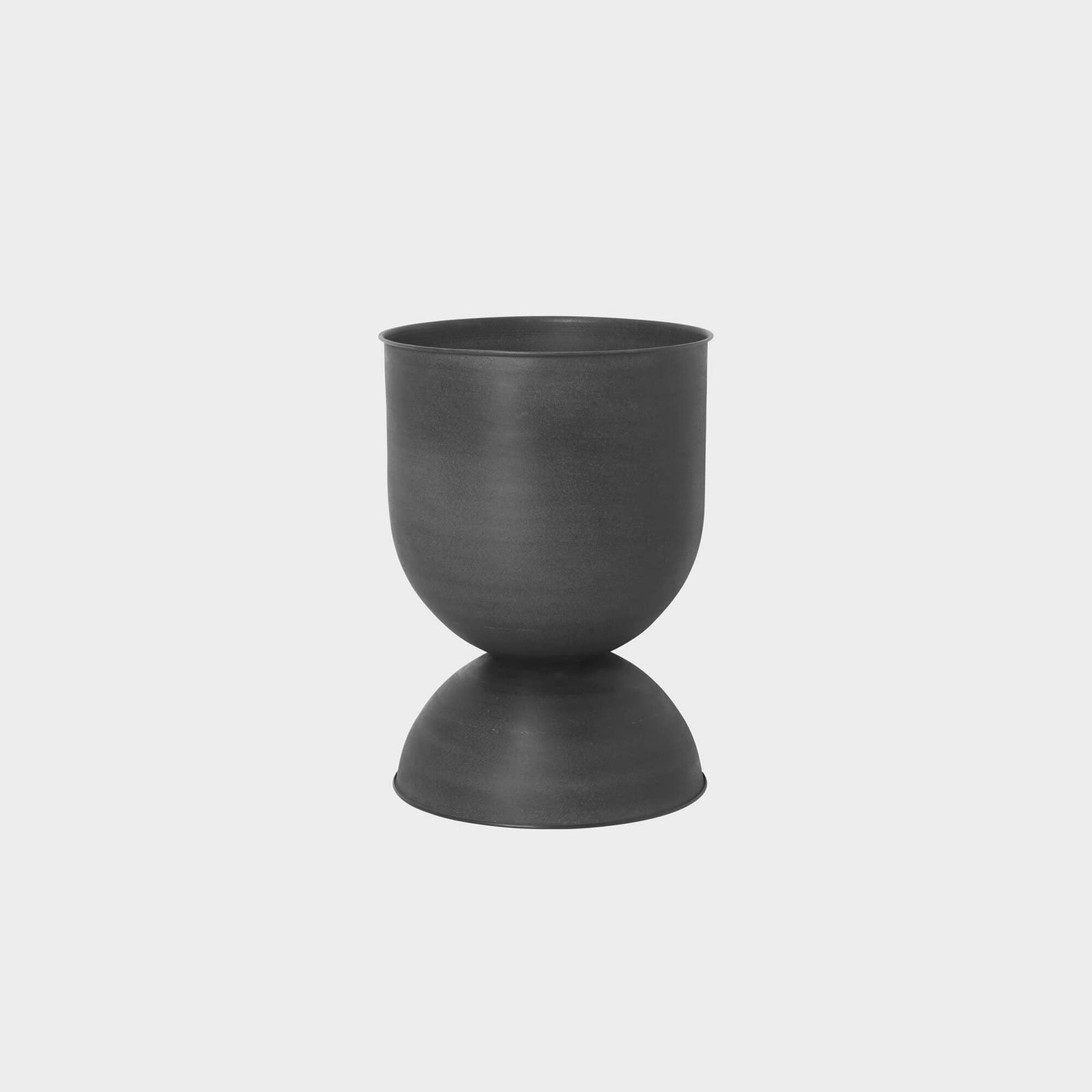 Hourglass Planter in matte black metal, versatile design for indoor or outdoor use, can be flipped for style and function.
