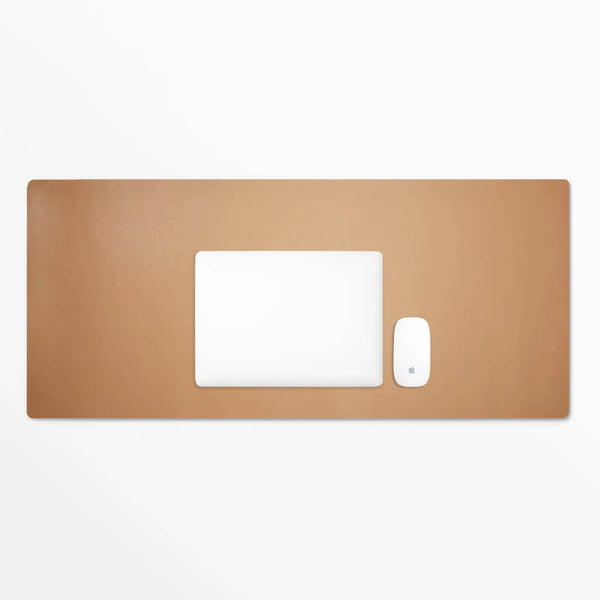 Brown leather desk pad with a white mouse and laptop, perfect for a modern workspace by Leatherology.