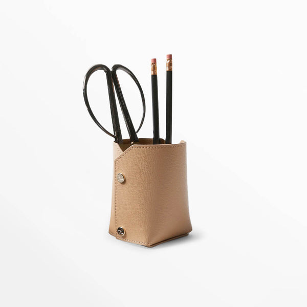 Leatherology modern pencil cup in tan leather with pencils and scissors, designed for portable workspace organization.