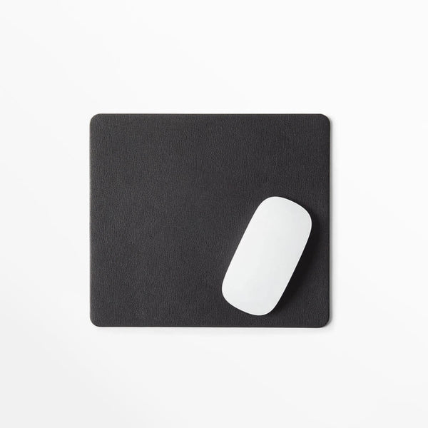 Sleek modern leather mouse pad with a white mouse, perfect for home or travel. Designed by Leatherology.