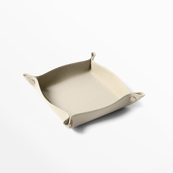 Modern leather valet tray in soft beige, ideal for organizing desk essentials. Made by Leatherology.