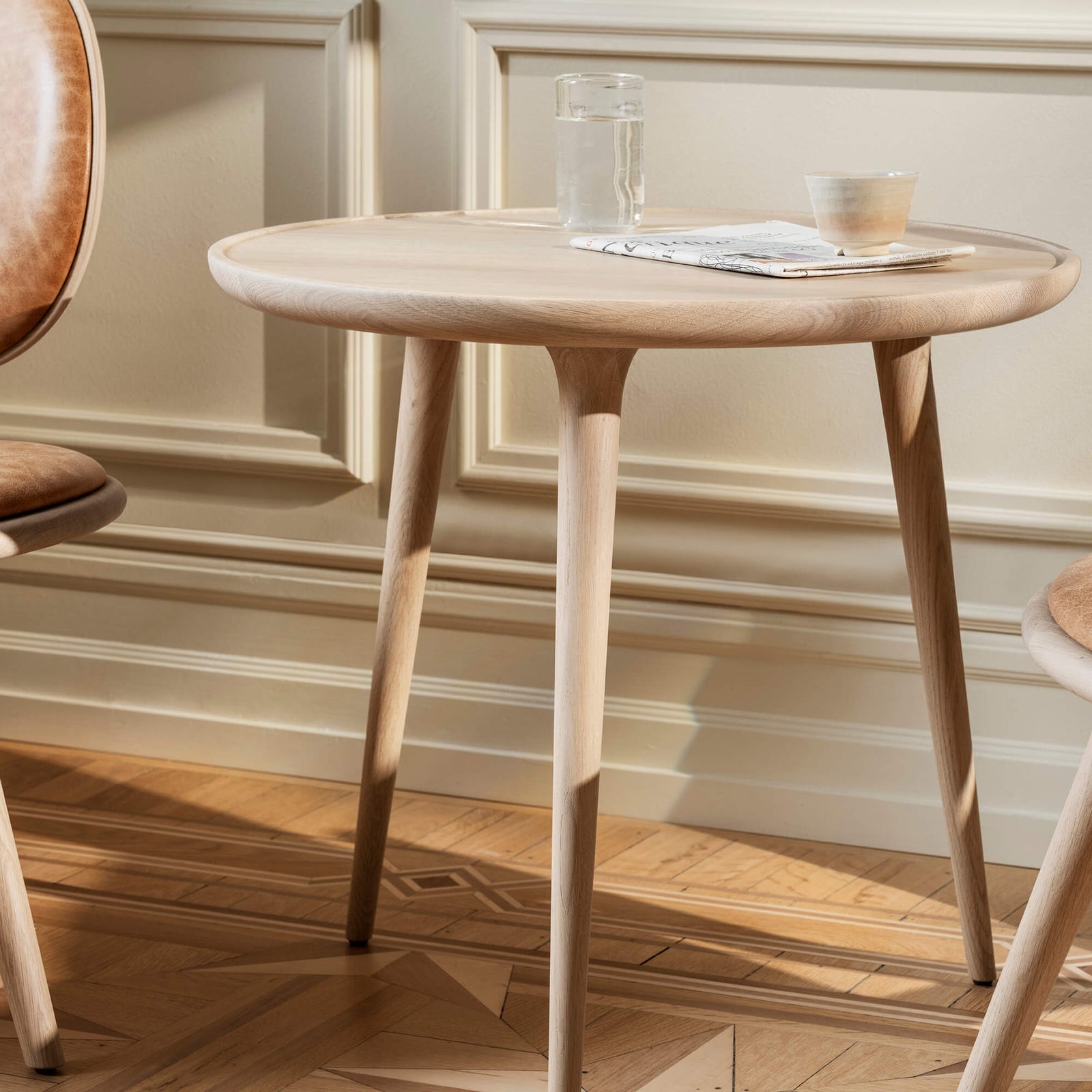 Small round wooden side table with items on top