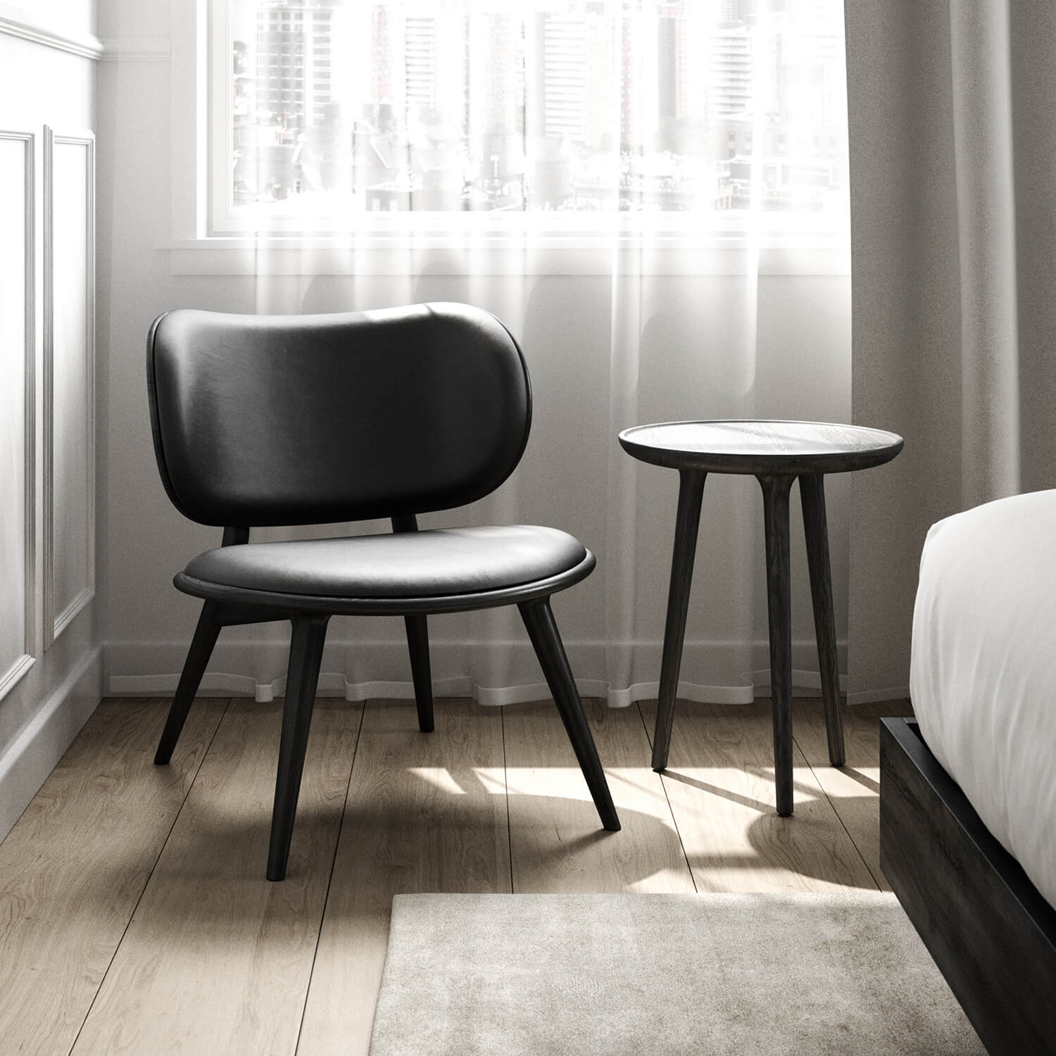 Small round side table next to a chair in a room